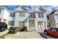 Inviting townhouse featuring a well-manicured lawn and convenient parking at 2780 Laurel Ridge Cir, East Point, GA 30344