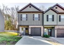 Charming townhome showcasing neat landscaping, a driveway, and a single-car garage at 1709 Creel Ln, South Fulton, GA 30349