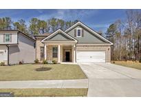 Inviting single-Gathering home featuring a manicured lawn and a two-car garage, creating a welcoming curb appeal at 221 Caledonia Ct, Peachtree City, GA 30269
