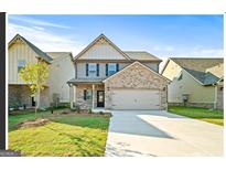Inviting two-story home with a well-manicured lawn and a spacious two-car garage at 2376 Aukerman Trce, Hampton, GA 30228