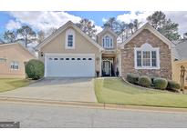 Charming home with a two-car garage and stone and stucco exterior at 221 Collierstown Way, Peachtree City, GA 30269