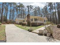 Charming home featuring a spacious yard, inviting front porch, and long drive at 179 Green Valley Rd, Fayetteville, GA 30214