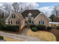 Charming brick home featuring manicured landscaping and a welcoming front entrance at 90 Oak Walk, Villa Rica, GA 30180