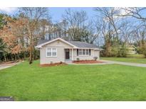 Charming single-story home with a well-maintained lawn and paved driveway at 1643 Columbia Dr, Decatur, GA 30032
