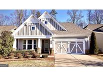 Charming home with a two-car garage, well-manicured lawn and attractive contrasting white and gray trim at 2455 Westlington Cir, Cumming, GA 30040