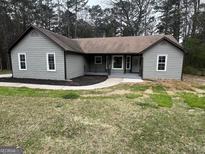 Charming single-story home with a welcoming front porch and freshly painted exterior at 127 Brookwood Estates Trl, Stockbridge, GA 30281