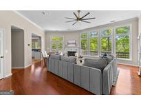 Bright living room boasts hardwood floors, fireplace, large windows, and an open floor plan at 679 Bo Bo Banks Rd, Grantville, GA 30220