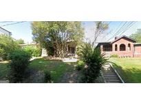 Charming brick home with mature trees and a well-maintained lawn at 586 Glen Iris Ne Dr, Atlanta, GA 30308