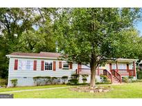 Charming single-story home with light green siding, wood shutters, a brick-lined entry, and a well-maintained front lawn at 2222 Beecher, Atlanta, GA 30311