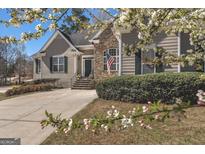 Charming home with stone accents, an American flag, and landscaped grounds at 1491 Hada Ln, Lawrenceville, GA 30044