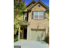 Charming two-story home featuring a symmetrical facade and an attached single car garage at 2742 Keystone Gates Ct, Lithonia, GA 30058