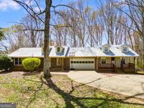 Charming single story house with brick and siding,dormer windows, 2 car garage and an inviting front porch at 327 Old Muse Rd, Carrollton, GA 30116