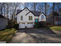 Charming two-story home featuring a two-car garage and a beautiful blue front door at 4911 Baker Plantation Way, Acworth, GA 30101