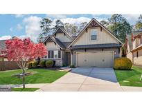 Charming home with an inviting front yard, featuring a well-manicured lawn and mature landscaping at 1005 Saranac Park, Peachtree City, GA 30269