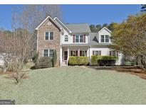 Charming two-story home with stone accents and well-manicured landscaping at 55 Sturgess Run, Sharpsburg, GA 30277