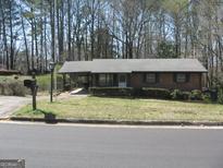 Charming brick home featuring a carport, well-maintained yard, and traditional details at 2102 Mulkey Sw Rd, Marietta, GA 30008