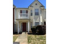 Charming townhome featuring a private balcony and a welcoming front entrance at 7236 Georges Way, Morrow, GA 30260