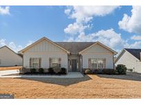 Charming single-story home with light-colored siding, decorative shutters, and well-maintained landscaping at 243 Summergate Ln, Villa Rica, GA 30180