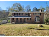 Charming two-story brick home with a well-maintained front yard, perfect for a Gathering at 1433 Butler St, Jonesboro, GA 30236