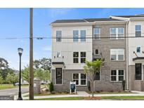 Beautiful exterior elevation of a modern townhome with brick and white siding at 2581 Astaire Ct, Atlanta, GA 30318
