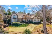 Charming two-story home with landscaped yard, circular driveway, and beautiful stone and stucco exterior at 610 Graystone Ct, Peachtree City, GA 30269