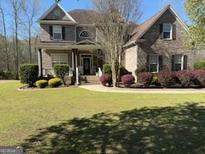Spacious backyard with a patio, fire pit, and ample space for outdoor activities at 711 Lily Glen Ln, Stockbridge, GA 30281