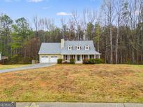 Charming one-story home featuring a welcoming front porch and well-maintained lawn at 118 Hunters Pl, Villa Rica, GA 30180