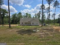 New construction home featuring light siding and a covered front porch on a spacious lot at 22638 Salem Church Rd, Metter, GA 30349