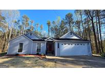 Charming single-story home with a well-manicured front yard and a two-car garage at 5802 Bay Pointe Sound Nw, Acworth, GA 30101