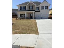 Two story home featuring a large front yard and a three-car garage at 375 Overlook Rd, Covington, GA 30014