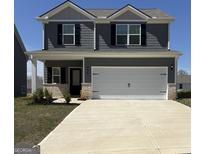 Charming two-story home with a wide driveway and attached two-car garage at 456 Prescott Way, Villa Rica, GA 30180