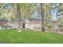 Charming single-story home with a well-maintained front yard and mature trees, offering great curb appeal at 1923 Rosewood Rd, Decatur, GA 30032
