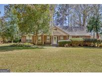Charming brick home with well-maintained lawn and mature landscaping at 110 Sycamore Bnd, Fayetteville, GA 30214