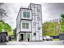 Stunning contemporary home featuring a unique geometric facade and a well-manicured lawn at 4450 Sterling Forest Dr, Decatur, GA 30034