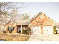 Charming single-story brick home featuring an attached two-car garage at 1109 Norsworthy Ml, Hampton, GA 30228