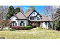 Stunning two-story home with lush landscaping and a well-manicured lawn at 4852 Jacobs Cove Pt, Buford, GA 30519
