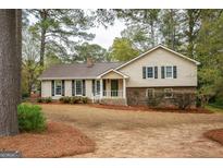 Charming single-Gathering home featuring a cozy front porch and well-maintained landscaping at 35 East Honeysuckle Ln, Carrollton, GA 30116