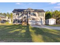 Charming two-story home featuring a well-manicured front yard, two-car garage, and inviting curb appeal at 217 Old Carrollton Rd, Carrollton, GA 30116