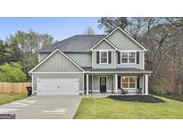 Charming two-story home with a well-maintained lawn and attached two-car garage at 205 Valley View Dr, Tyrone, GA 30290