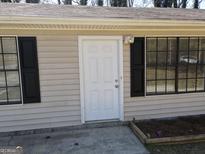 The exterior front door of this home features dual windows and a light fixture at 61 Scoby Ct, Jonesboro, GA 30238