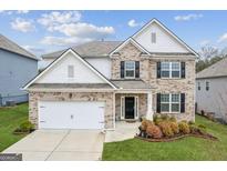 Charming two-story home with well-maintained lawn and landscaping features a two car garage at 4365 Sunflower Cir, Cumming, GA 30040