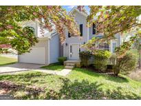 Charming home exterior with flowering tree, well-maintained lawn, and inviting entrance at 4542 White Rd, Douglasville, GA 30135