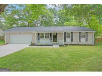 Charming single-story home with a well-manicured lawn and inviting front porch at 5784 Sharon Dr, Norcross, GA 30071