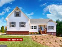 Charming two-story home featuring a full basement, brick accents, and a well-manicured lawn at 217 Point Ridge Ct, Temple, GA 30179
