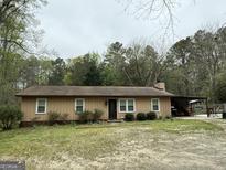 Charming single-story home featuring a covered patio and a classic brown exterior at 4389 & 4381 Campbell Rd, Snellville, GA 30039