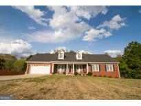 Charming, single-story brick home featuring a two-car garage and dormer windows at 237 Summerford Pl, Stockbridge, GA 30281