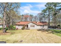 Charming single-story home with a well-maintained lawn and mature trees in a peaceful setting at 104 Amberidge Nw Dr, Cartersville, GA 30121