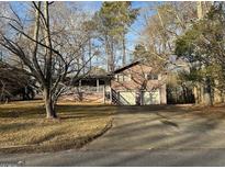 Split level home featuring an attached two car garage and covered front porch at 191 Charles Cox Dr, Canton, GA 30115