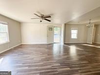 Bright living room with wood flooring, ceiling fan and natural light at 710 Bluebird Se Dr, Conyers, GA 30094