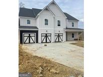 Charming two-story home boasts a three-car garage with modern black and white doors at 138 Silvercrest Dr # 169, Acworth, GA 30101